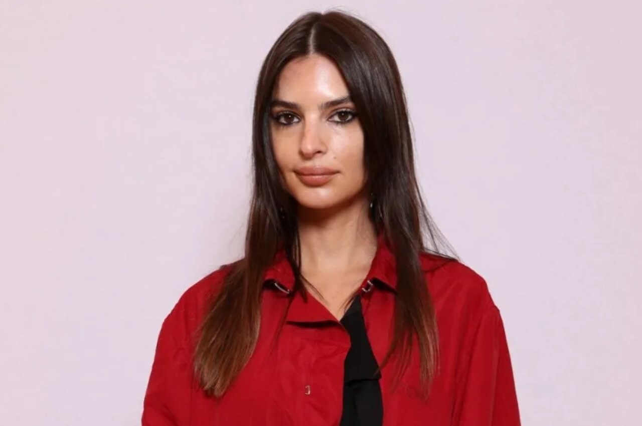 Emily Ratajkowski in a bathrobe, smiling with tousled hair in a chic Instagram photo.