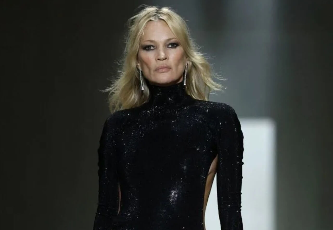 Kate Moss stuns in a daring backless Gucci dress with iconic detailing.