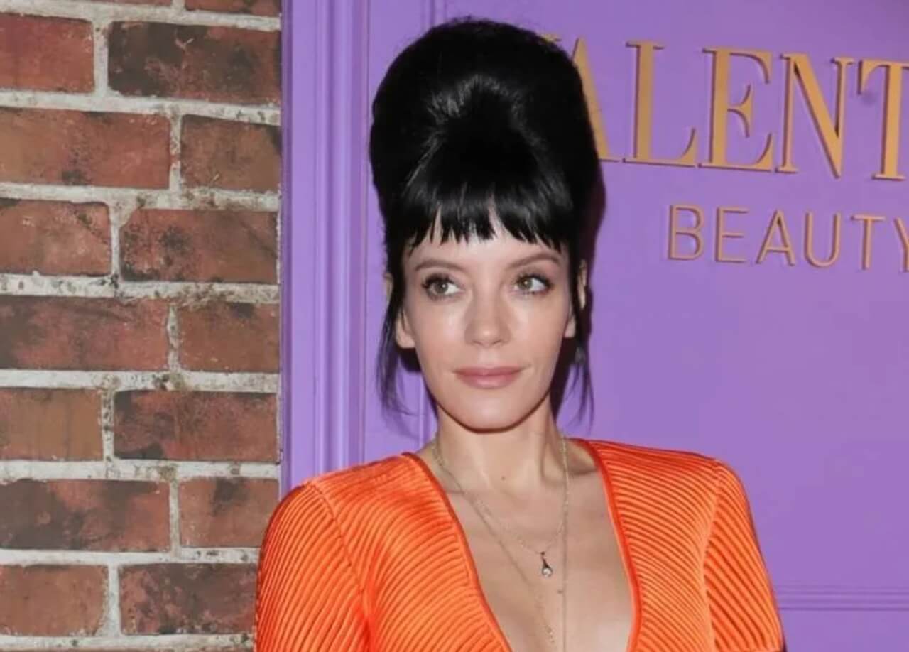 Lily Allen in bold orange Valentino top with oversized bow at London event.