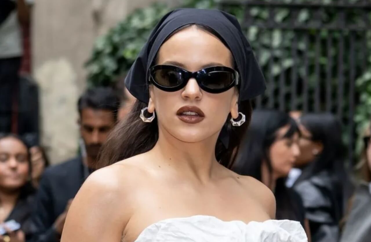 Rosalía in silver high-slit Calvin Klein dress with wet-look hair