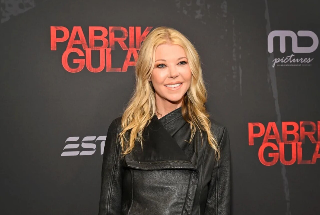 Tara Reid poses on red carpet in elegant gown after reflecting on hotel incident.