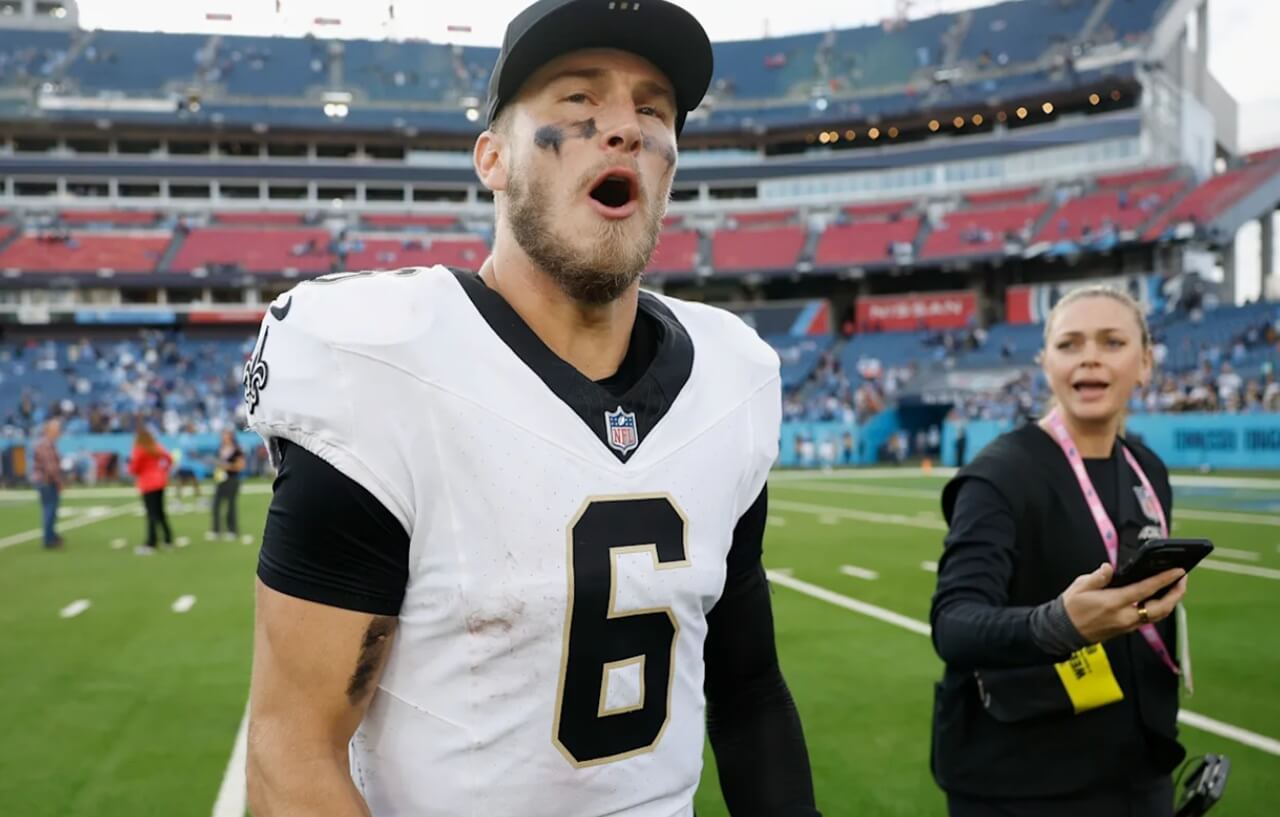 Saints QB Tyler Shough with wife Jordan holding their newborn son Grayson.