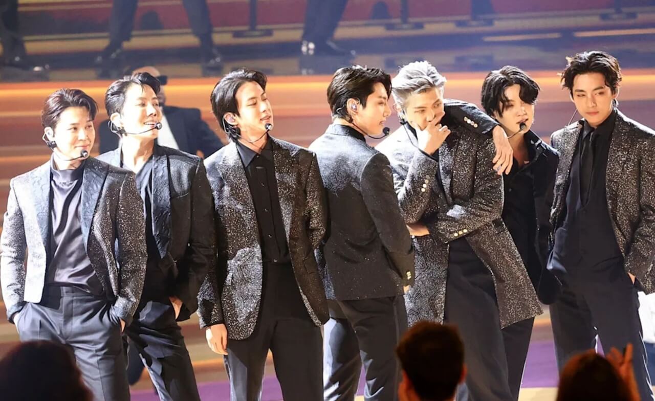 BTS reunited onstage at Gwanghwamun Square with fans cheering.