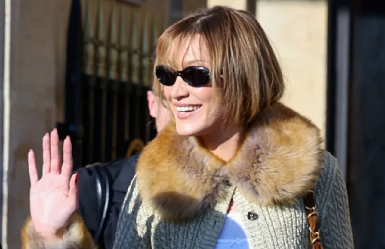 Bella Hadid in a red bodysuit and sheer black skirt at the YSL runway show during Paris Fashion Week.