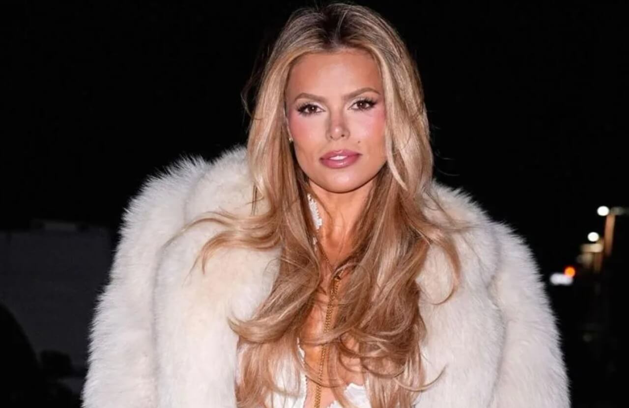 Brooks Nader stuns in bold high-slit skirt and corset top at Layer Zero event.