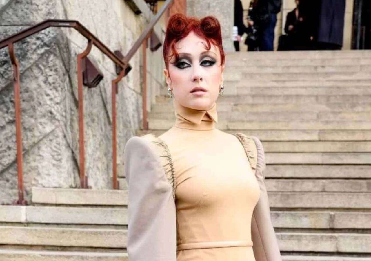 Chappell Roan with bold smoky eye makeup and structured outfit at Mugler show.