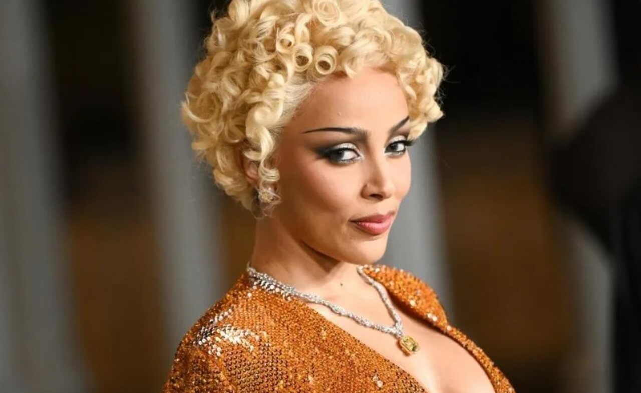 Doja Cat in nude bodysuit with pixie cut and red lipstick for Vogue.