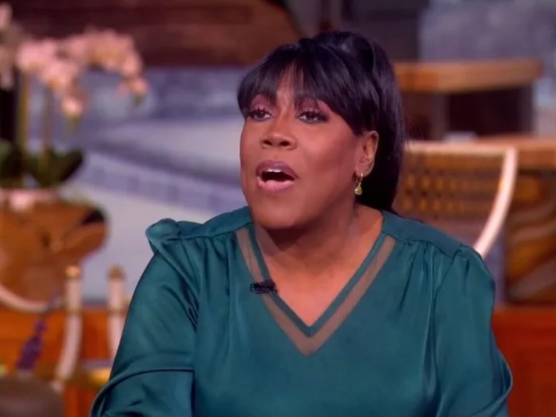 Sheryl Underwood guest hosting The View, smiling at the panel table.