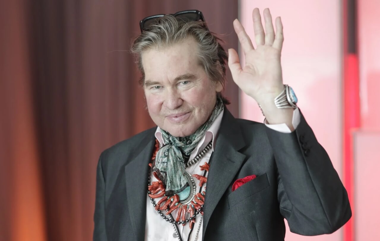 Val Kilmer at film premiere, smiling warmly.