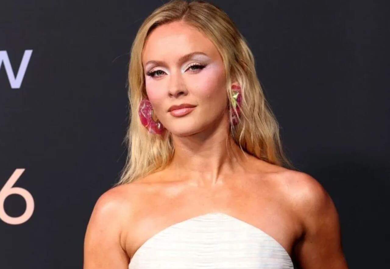 Zara Larsson dazzles in sparkly charm bikini top on stage.